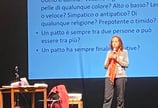 a woman standing on a stage with a microphone and a microphone