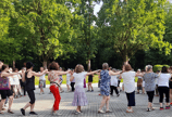 a group of people standing around a circle with their arms outstretched out