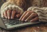 a woman's hands on a laptop computer