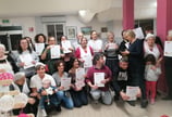 a group of people holding up certificates and holding up certificates