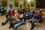 a group of people sitting in chairs in a room