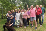 a group of people standing in a field with a dog