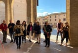 a group of people standing in a line of arches