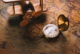 a pocket watch with a compass on a map