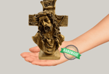 a hand holding a cross on a hand