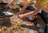 a group of children playing in a sandbox