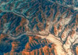 a view of a mountain range with a river running through it. arbab naimat kasi , balochistan ,pakista