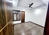 Spacious Bedroom of 3 BHK Builder Floor Near Sky Mansion Chattarpur with false ceiling and window