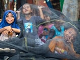 a child's face is covered in a veil of veils