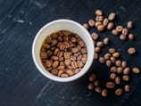 a cup of coffee beans and coffee beans