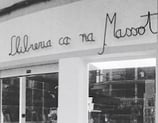 a store front of a store with a woman in a dress