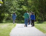 Photo of people walking on a paved path