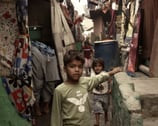 a young boy standing in a narrow lane of kathputli colony
