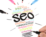 a person holding a pen and writing on a paper