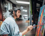 A female artist working on a painting