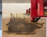 a machine that is cutting through a piece of wood