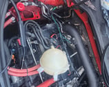 Battery wires inside engine compartment