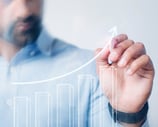 a man is drawing a graphenene graphing on a white board
