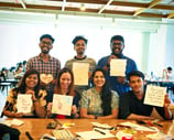 a group of employees holding up signs that say thank