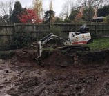 Mini digger excavating trench in Selly Oak garden