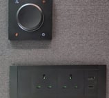 Power outlet panel with dial switch on felt wall