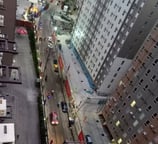 a city street scene with a train on the tracks