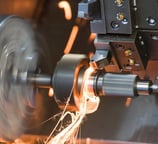 a machine is grinding a metal part of a machine