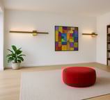 a living room with a red ottoman and a red ottoman