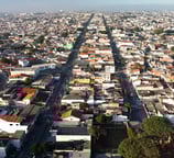 Vista aérea mostrando a densa malha urbana e suas avenidas principais.