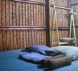 Simple yet airy room facing an open courtyard with rustic wood and nature all around.