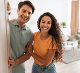 Young couple at the entrance to their home