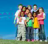 Colorful group of children on a hilltop
