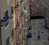 a group of people walking around a courtyard