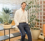Fertility clinic specialist welcoming patients in a modern lounge area.