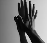a man's hand pressed against the wall casting a shadow in black & white photo for LVF shadow work
