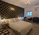 a bedroom with a bed and a chair