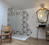 a bathroom with a chair and a mirror
