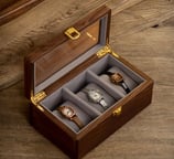 a wooden box with three watches and a watch