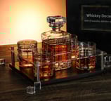 a set of whiskey glasses and a bottle of whiskey
