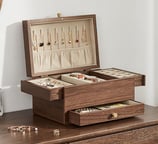 a jewelry box with jewelry and jewelry on a dresser