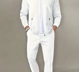 a man in a white suit and a white shirt