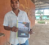 Yadir Centeno with his solar PV technician textbook