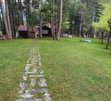a stone path leading to a small cabin