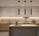 a kitchen with a large island and a potted plant cilindri su isola