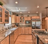 Fully equipped kitchen at Moose Creek Lodge with stainless steel appliances, granite countertops.