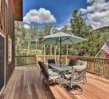 Mountain-view deck with outdoor dining and umbrella at Moose Creek Lodge.