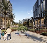 A family walking along One Ninety’s pedestrian promenade surrounded by palm trees, fountains