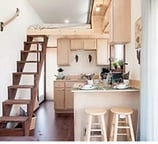 Cozy kitchen and loft space inside tiny home pod