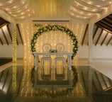 a wedding reception table with a white table cloth draped over it