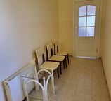 a room with a table and chairs and a door